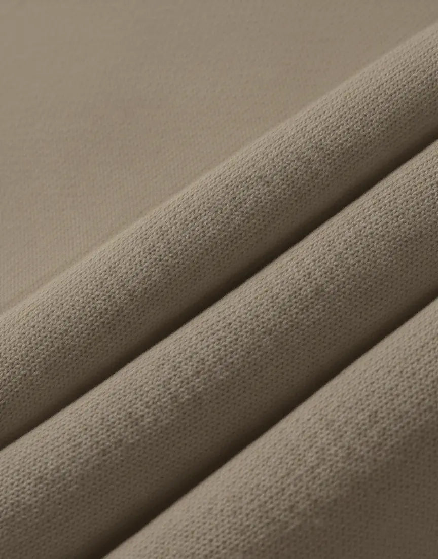 Close-up of textured brown fabric with a subtle pattern