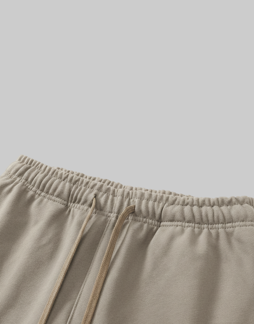 Close-up of beige shorts with drawstring on a white background