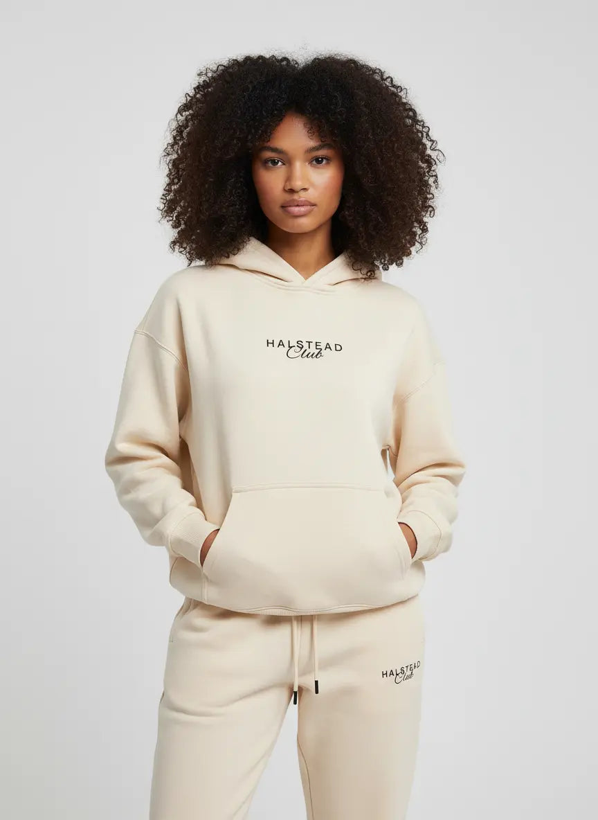Person wearing a beige hoodie and pants with 'Malstead Club' branding on a white background