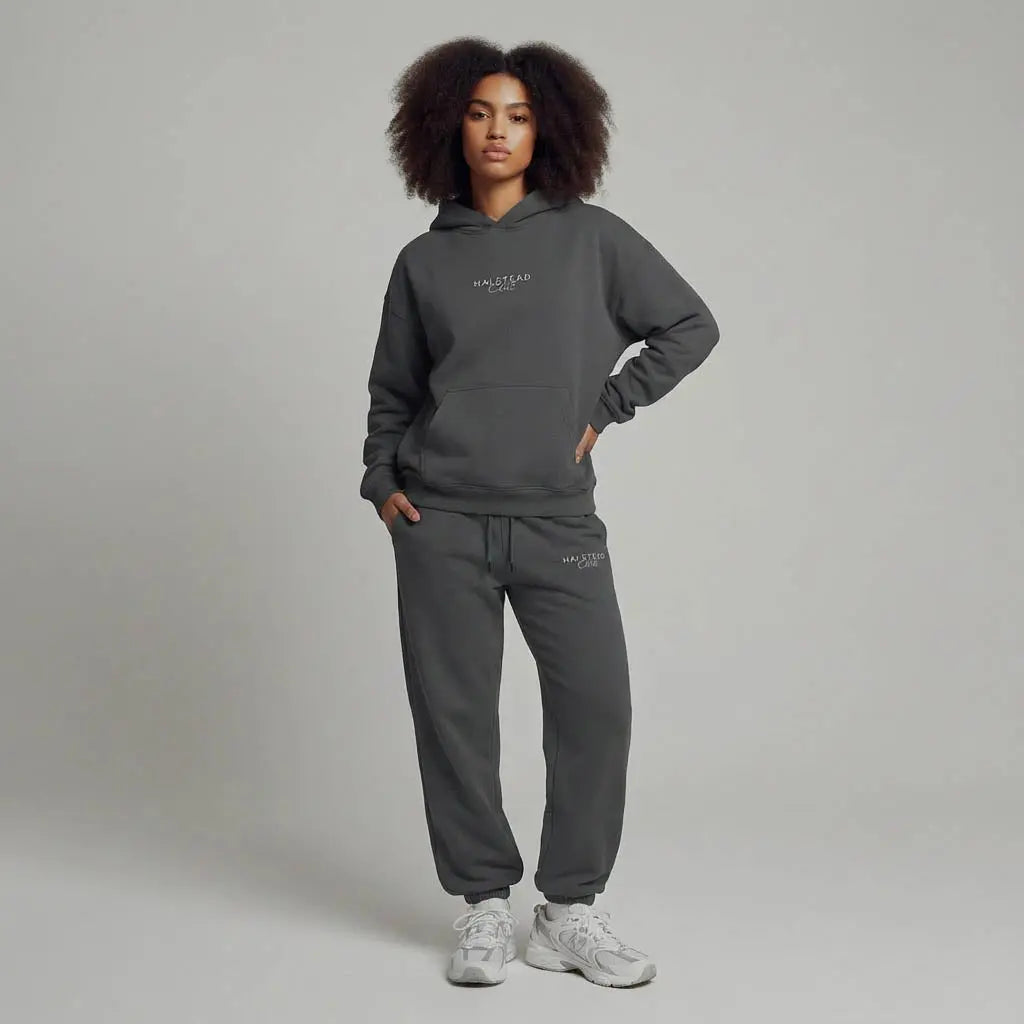 Person wearing a gray hoodie and pants with 'Malelions' branding on a plain background