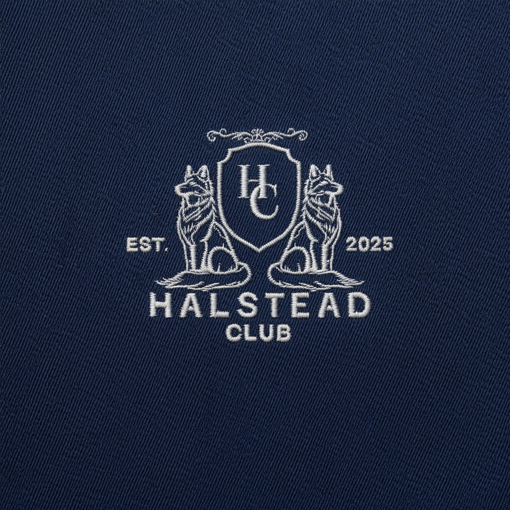 Navy blue fabric with embroidered white logo and text 'Halstead Club' on a dark blue background