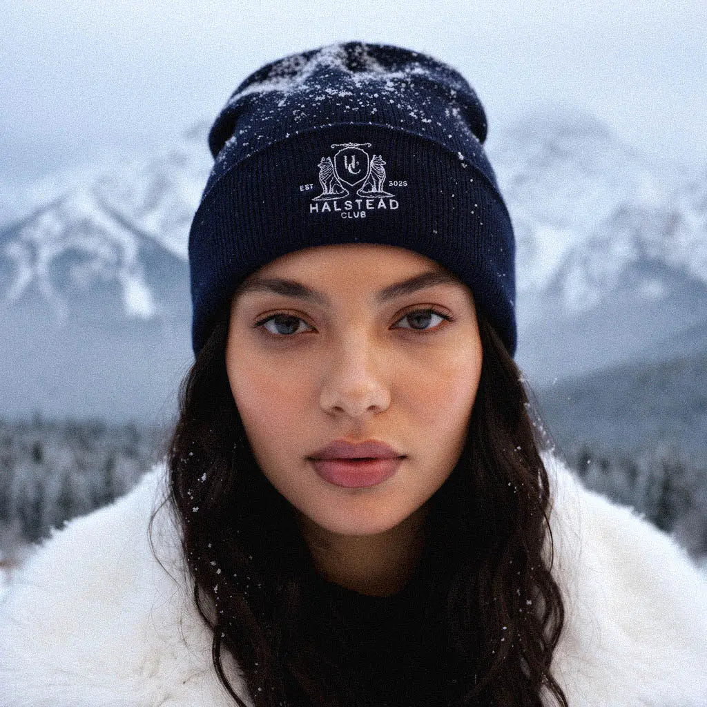 Person wearing a Malstead Club beanie in a snowy mountain landscape
