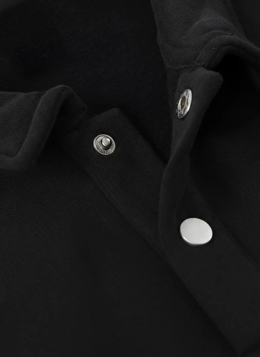 Close-up of a black coat with silver buttons