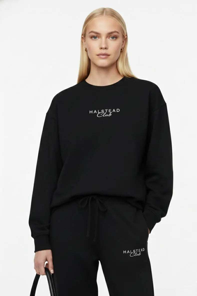 Person wearing a black sweatshirt with 'Halstead Club' logo on a white background