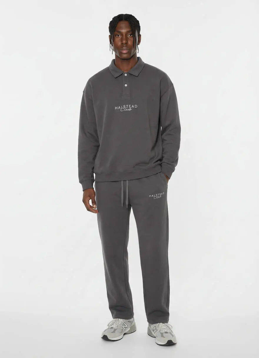 Person wearing a gray tracksuit with 'Halfstead' logo on a white background