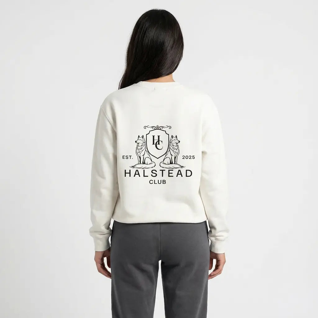 Person wearing a white sweatshirt with 'Halstead Club' logo on the back against a white background
